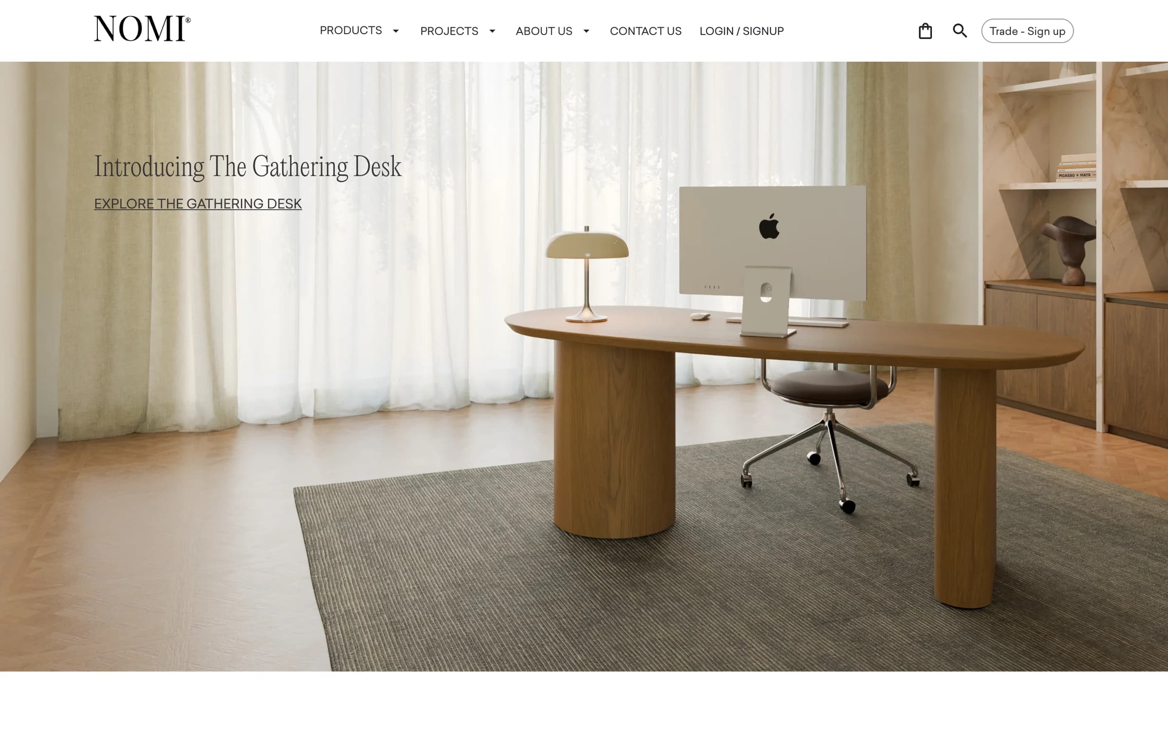 The NOMI storefront, showing the Gathering Desk styled in an interior setting.